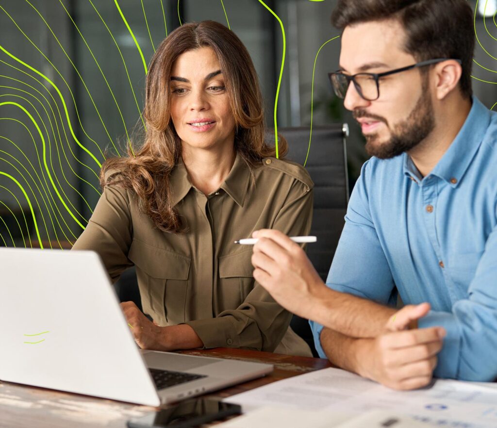 Two people discussing around a laptop