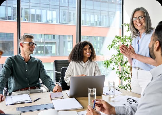 Team members conversing around a meeting table